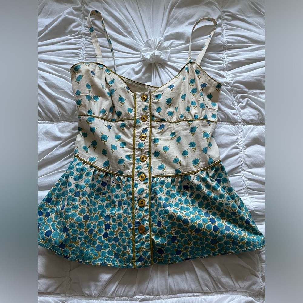 Sleeveless corset looking top with button in the front from Anthropologie.